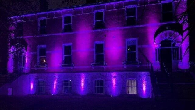 NDA Building lit up purple - IDPWD 2023
