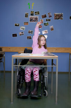 Girl using a wheelchair in an educational setting