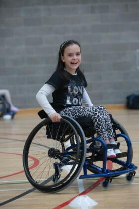 Child using a wheelchair and playing sport