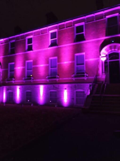 Outside of NDA building lit up purple