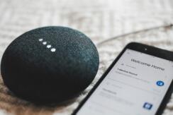 Google Home Mini and smartphone with Google Home app