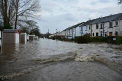A row of houses with flooding in the road
